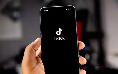 TikTok on a cellphone in someone's hand