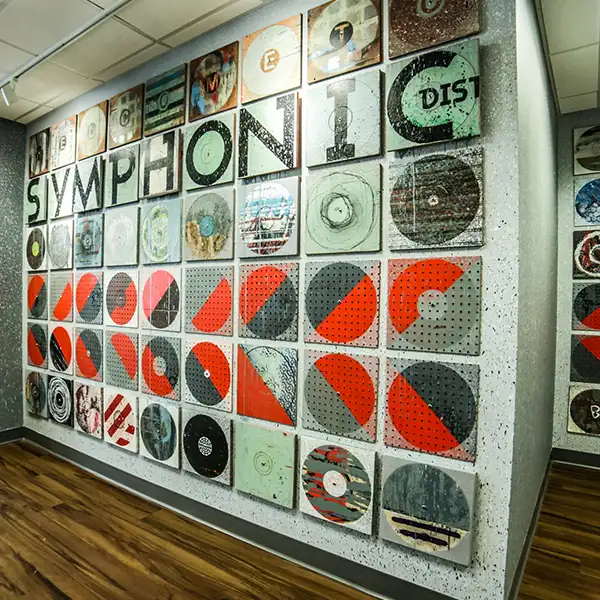 Symphony CDs alongside a letter from Symphonic's CEO displayed on the office wall.