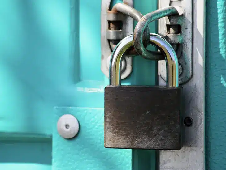 A padlock on a blue door with a Letter from Symphonic's CEO attached.