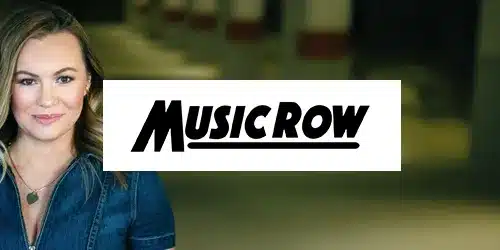 A woman stands next to a "Music Row" sign, partially obscured by the press of the sign. The background is blurred with indistinct details.