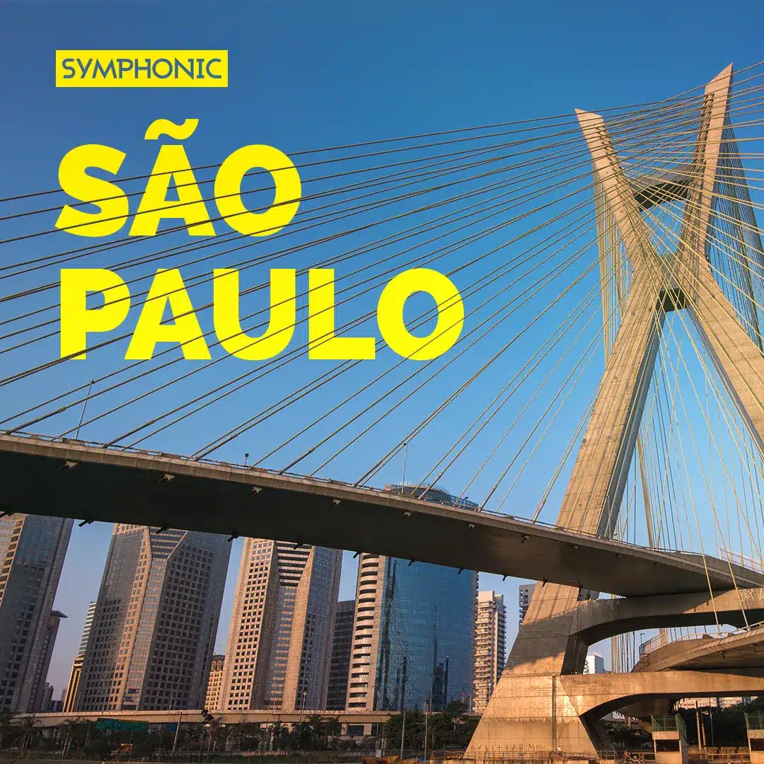 Octávio Frias de Oliveira Bridge in São Paulo, towering majestically with skyscrapers as a symphonic backdrop under the expansive blue sky.