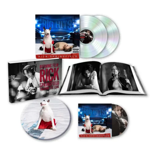 Box set featuring Rick Springfield’s “Big Hits” album, offering physical music distribution with two vinyl records, two CDs, a photo booklet, and artwork of a white dog with a red frisbee on stage.