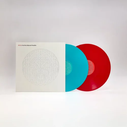 A vinyl record set exemplifying physical music distribution, with one blue and one red disc, is displayed next to a white album cover featuring a geometric circular design and the title "OK Go: And the Adjacent Possible.