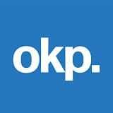 White lowercase letters "okp." on a solid blue square background, reflecting the clean and modern aesthetic found in About Symphonic branding.